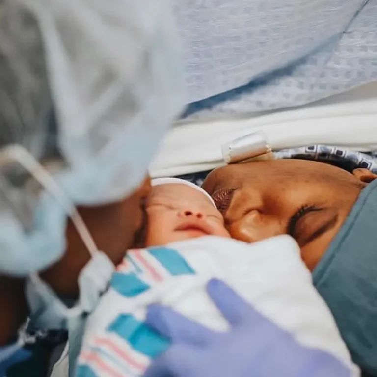 Young Couple Kissing Baby 768x768